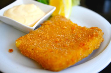 fried breaded cheese close up , served on a plate . clipart