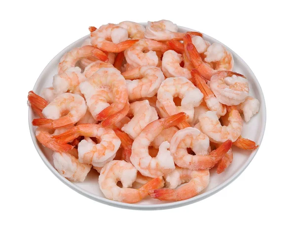 A large pile of boiled frozen shrimp on a white plate. Isolated on white