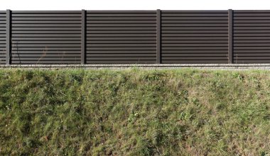 Çimenli tepe manzaralı ahşap çitler. Beyazda izole edilmiş