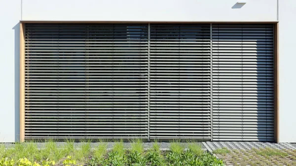 The large window of a modern school is protected from the  sun by blinds