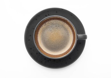 Large black coffee in porcelain cup with saucer on white. Top view.