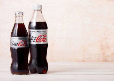 LONDON, UK - AUGUST 03, 2018: Plastic bottles of Diet Coke Coca Cola soft drink on wood. Most popular drink in the world