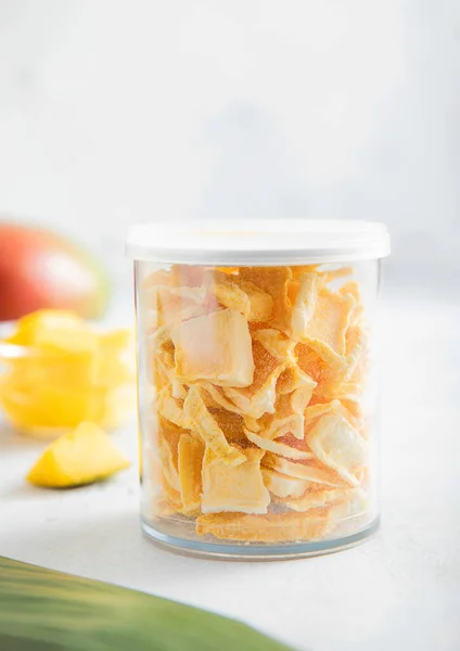 Freeze Dried Mangoes Cereal Plastic Jar Light Background Macro — Stock Photo, Image