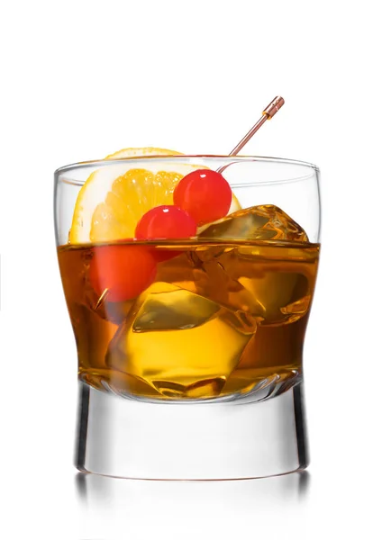 Old fashioned cocktail with cherries on still pick and orange slice on white.