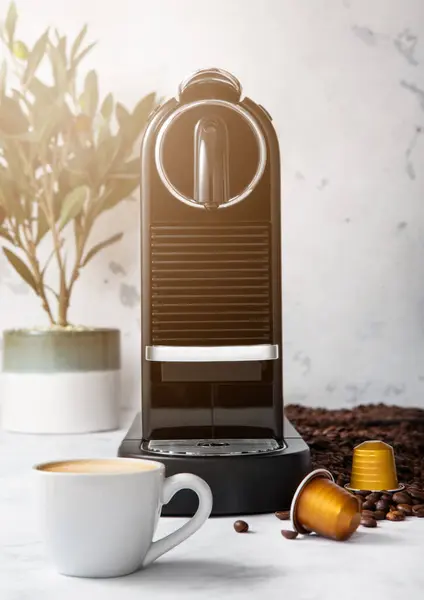 Coffee machine with cup and coffee capsules pods in light morning kitchen and sun light with coffee beans and plant
