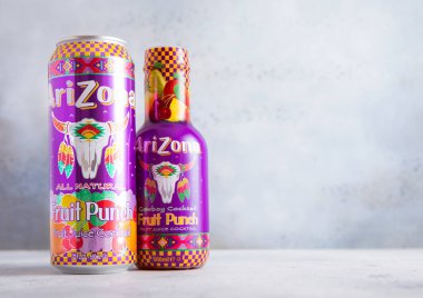 LONDON,UK - AUGUST 22, 2025: Bottle and tin of Arizona Fruit Punch iced tea drink with real juice on light table.