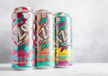 LONDON,UK - MARCH 30, 2025: Three aluminum cans of real brewed Arizona iced tea drink on table.