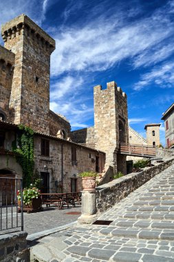 İtalya 'nın Bolsena şehrinde taş binalar bulunan Cobbled caddesi.