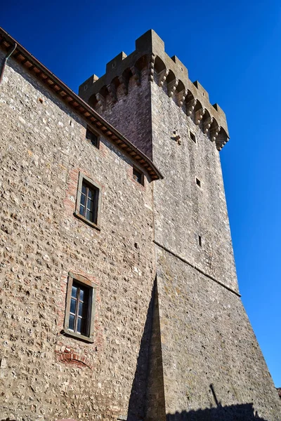 stone tower of a medieval castle in the village of Capalbio, Italia