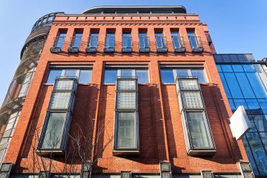 wall with windows and balconies of a renovated building of an old brewery in the city of Poznan, Poland