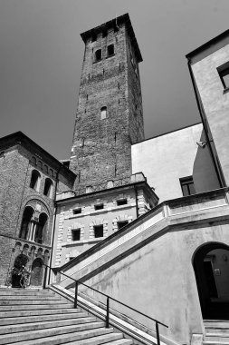 Stone stairs and medieval bell tower of an historic church in the city of Padua, Italy, monochrome
