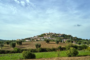 tower of a stone medieval church in the village of Montiano in Tuscany, Italy