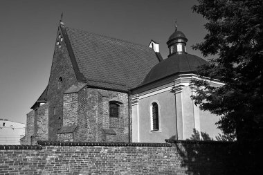 medieval, historic church behind a brick wall in Poznan, monochrome