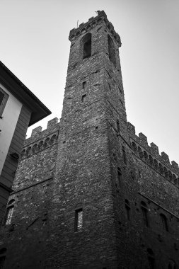 medieval stone castle in a tower in the city of Florence, Italy, monochrome