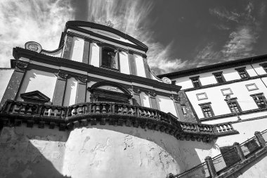 Facade of an historic building with stone steps in the town of Gradoli, Italia, monochrome