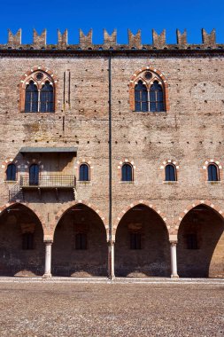 historic brick building with portico and windows, Palazzo del Capitano in the city of Mantua, Italy