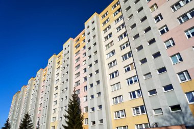 facade of a modern multi-storey residential building with balconies and windows in the city of Poznan, Poland