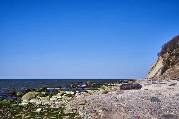 stock image Baltic sea coast with sandy beach and cliff overgrown with trees on Wolin island, Poland