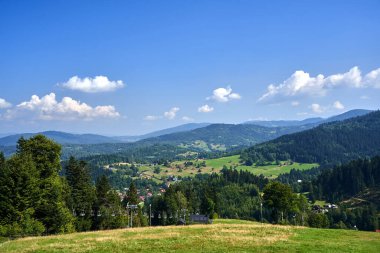 grassy slope of Pilsko mountain and chairlift in Beskid Mountains, Poland clipart