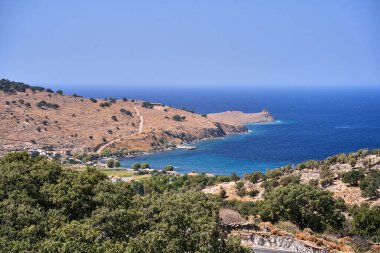 Kayalıklardaki tepeler, ağaçlar ve evler, Yunanistan 'ın Lezbiyen Adası' ndaki deniz kıyıları