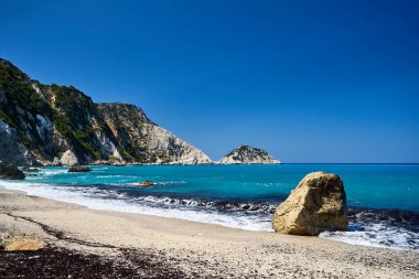 Yunanistan 'ın Cephalonia adasındaki Petani Körfezi' ndeki kumlu sahilde kayalar.