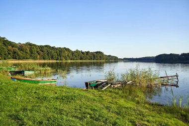 Eski, harap olmuş balıkçı iskelesi ve göl kıyısındaki tekne, Polonya