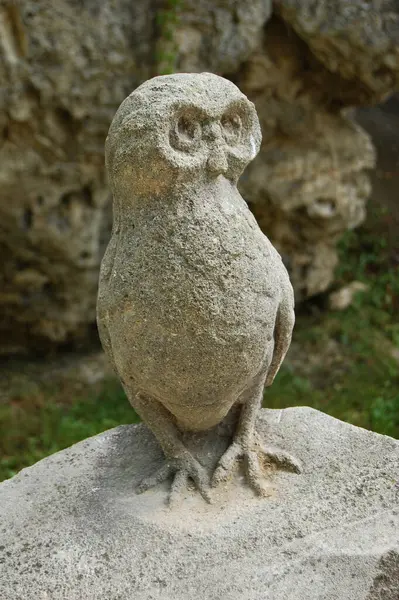 statue of owl sitting on stone