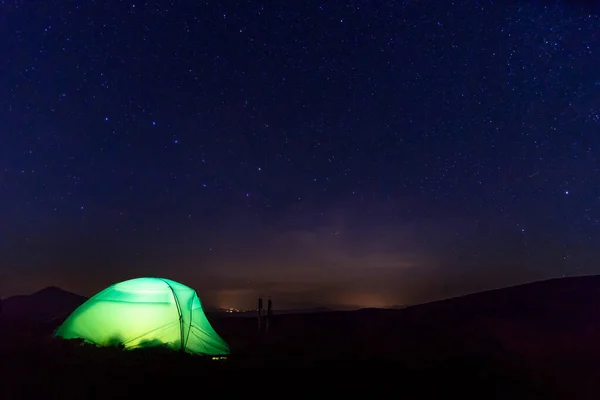 Hiking tent in the starry night. Beauty of outdoor camping