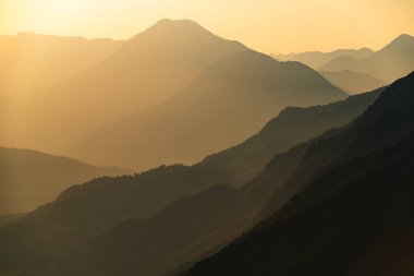 Sunset in Julian alps. Soca valley, Slovenia. Colorful mountain sunset with hill silhouettes