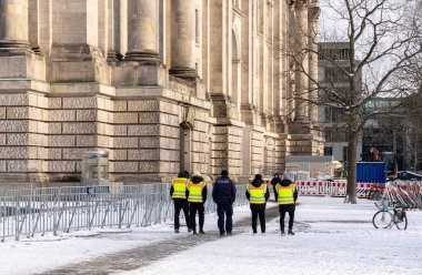 Group of police officers with yellow safety vests, Reichstag, Berlin, Germany clipart