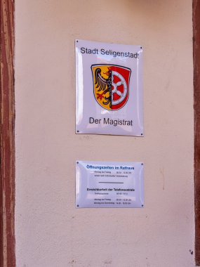 Coat of arms and information signs at the entrance to the town hall and the registry office, Seligenstadt, Hesse, Germany clipart