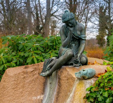 Bronze figure sitting on a piece of rock, Glienicke Palace Berlin Wannsee, Berlin, Germany clipart