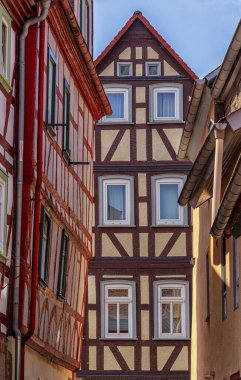 The picture shows the diverse and typically German historical architecture with half-timbered houses in the old town of Bdingen, Hesse, Germany