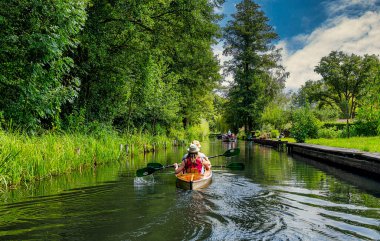 Tourism in Brandenburg, landscape with flowing waters, houses, kayaks, and forest area in the Spreewald in Lbbenau and Lehde, Brandenburg, Germany