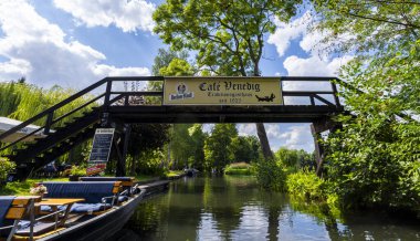 Tourism in Brandenburg, landscape with flowing waters, houses, kayaks, and forest area in the Spreewald in Lbbenau and Lehde, Brandenburg, Germany
