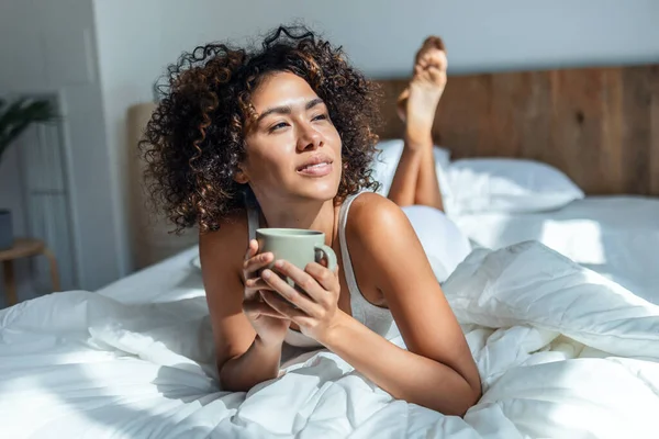 Yatakta Yatarken Bir Fincan Kahve Içen Güzel Bir Kadın — Stok fotoğraf