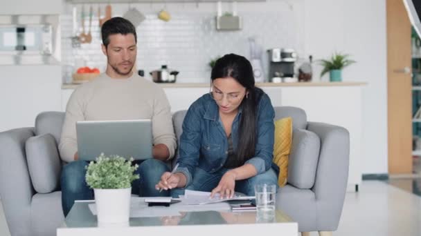 Video Exhausted Couple Using Laptop Consulting Some Invoices Documents While — Stock Video