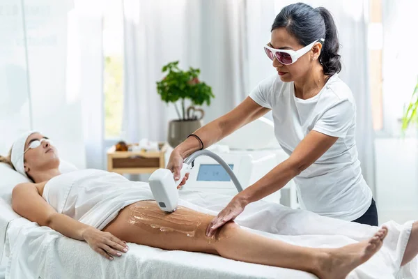 Shot Cosmetologist Doing Laser Treatment Her Legs Beauty Salon — 스톡 사진