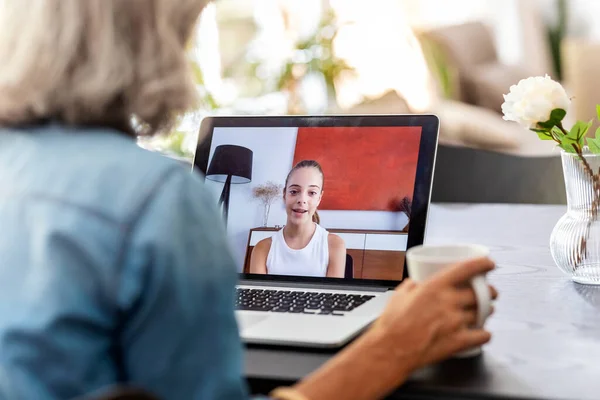 Back View Grandmother Speaking Videocall Her Granddaughter Using Laptop Home — Zdjęcie stockowe