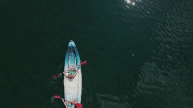 Video of drone view video of a mother and her daughter kayaking down the river