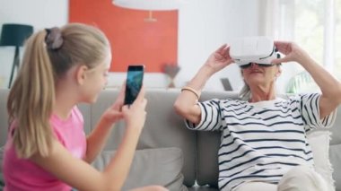 Video of granddaughter teaching her grandmother how to play video games with 3d glasses in the dining room at home