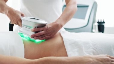 Video of cosmetologist makes the procedure an ultrasonic cleaning of skin of a beautiful woman on the spa center.