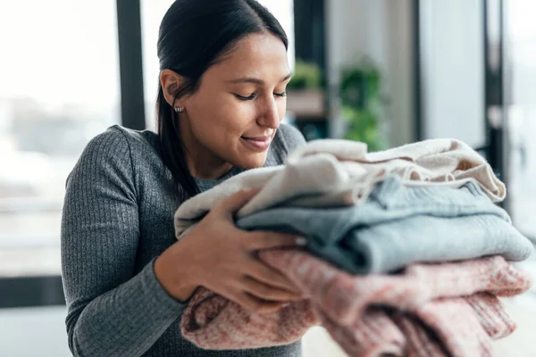 Shot Beautiful Young Woman Holding Smelling Clean Clothes Home — Stockfoto
