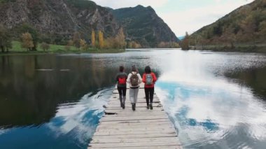 Göl kıyısındaki bir rıhtımda duran güzel bir ailenin videosu.