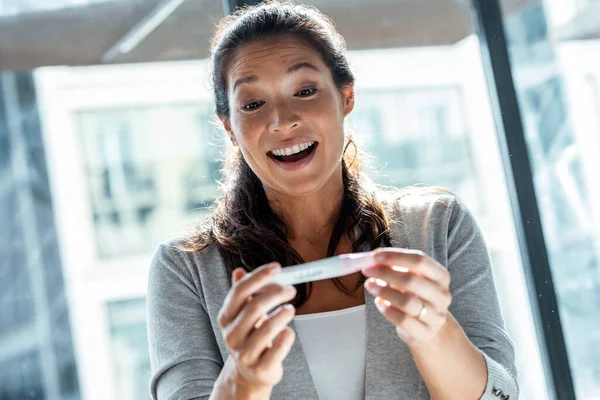 Shot Happy Woman Celebrating While Looking Predictor Finding Out She — Stock Photo, Image