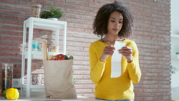 Video Schöne Frau Überprüft Einkaufsticket Während Sie Papptüte Mit Gesundem — Stockvideo