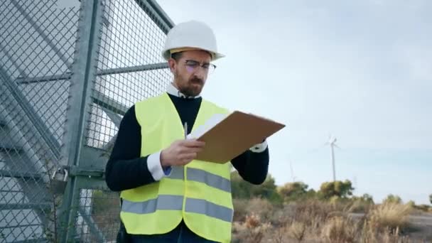 Video Mature Male Engineer Checking While Taking Notes Wind Turbines — Stock Video