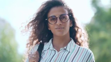 Parkta yürürken doğanın tadını çıkaran güzel bir kadının videosu.