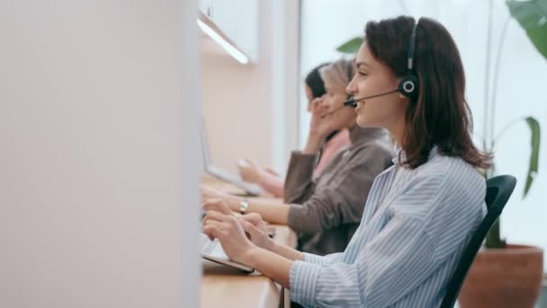 Ofisteki Dizüstü Bilgisayarda Bilgi Ararken Kablosuz Kulaklıkla Konuşan Kadın Operatörün — Stok video