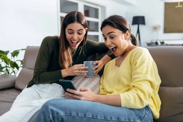 Shot Two Smiling Young Women Talking While Watching Smartphone Sitting — Fotografia de Stock